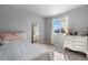 Neutral bedroom with a bed, dresser, mirror, a window with curtains, and décor accents at 26818 E 1St Pl, Aurora, CO 80018