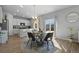 Bright dining area features a glass table, stylish chairs, and easy access to the outdoor space through sliding glass doors at 26818 E 1St Pl, Aurora, CO 80018