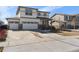 Charming two-story home with a three car garage, white siding, and stone accents at 26818 E 1St Pl, Aurora, CO 80018