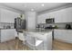 Well-lit kitchen with stainless steel appliances, white cabinets, granite countertops, and a central island at 26818 E 1St Pl, Aurora, CO 80018
