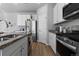 Modern kitchen featuring white cabinetry, granite countertops, and stainless steel appliances and gas range at 26818 E 1St Pl, Aurora, CO 80018