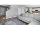 Open-concept living room with hardwood floors, a comfortable sofa, and easy access to the kitchen at 26818 E 1St Pl, Aurora, CO 80018