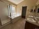 Bright bathroom featuring a soaking tub with glass block window and double sinks at 20148 E Dartmouth Dr, Aurora, CO 80013