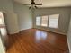 Spacious bedroom features wood floors, a ceiling fan, and sunny windows at 20148 E Dartmouth Dr, Aurora, CO 80013