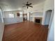 Open-concept living room with hardwood floors, fireplace, and view of kitchen at 20148 E Dartmouth Dr, Aurora, CO 80013