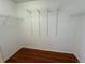 A spacious walk-in closet with adjustable shelving and wood flooring at 20148 E Dartmouth Dr, Aurora, CO 80013