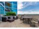 Relaxing outdoor seating area on a balcony with plants and views of the city skyline at 1700 Bassett St # 1102, Denver, CO 80202