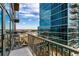 City views from private balcony with glass and steel building reflected at 1700 Bassett St # 1102, Denver, CO 80202