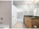 Bathroom with stone tiled shower, granite counters, and wood vanity at 1700 Bassett St # 1102, Denver, CO 80202
