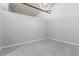 Bright bedroom with neutral walls, carpet, and a modern light fixture on a concrete ceiling at 1700 Bassett St # 1102, Denver, CO 80202