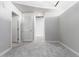 A well-lit bedroom with neutral carpet, white trim, and doors leading to closet spaces at 1700 Bassett St # 1102, Denver, CO 80202