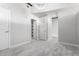 Light-filled bedroom featuring neutral carpet, a modern light fixture, and multiple closet spaces at 1700 Bassett St # 1102, Denver, CO 80202