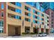 Exterior shows Glass House building entrance with covered parking and balconies at 1700 Bassett St # 1102, Denver, CO 80202