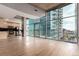 Spacious living area with floor-to-ceiling windows, an attached kitchen, and access to a balcony at 1700 Bassett St # 1102, Denver, CO 80202