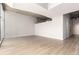 Open-concept living area with wood floors and large windows, offering ample natural light at 1700 Bassett St # 1102, Denver, CO 80202