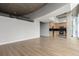 Spacious living area connected to a modern kitchen under an architectural concrete ceiling at 1700 Bassett St # 1102, Denver, CO 80202