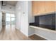 Bright living room with hardwood floors, a workspace and large windows showcasing city views at 1700 Bassett St # 1102, Denver, CO 80202