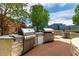 Outdoor kitchen features stainless steel grills and counters and city views at 1700 Bassett St # 1102, Denver, CO 80202