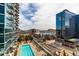 Stunning aerial view of pool area, surrounded by multiple buildings, and greenery at 1700 Bassett St # 1102, Denver, CO 80202