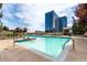 Outdoor pool area boasts lounge chairs, an ADA chairlift, city views, and blue skies at 1700 Bassett St # 1102, Denver, CO 80202