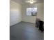 View of a basement area with newly painted walls, floors, and a modern window at 4445 E Florida Ave, Denver, CO 80222