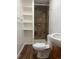 This bathroom features a tiled shower, wood shelving, and modern fixtures at 4445 E Florida Ave, Denver, CO 80222