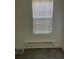 A bedroom showcasing a window with blinds and radiator heater at 4445 E Florida Ave, Denver, CO 80222