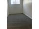 Cozy room features a window for natural light, neutral walls, and a grey floor at 4445 E Florida Ave, Denver, CO 80222