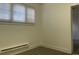 The bedroom boasts natural light, neutral walls, and radiator heat at 4445 E Florida Ave, Denver, CO 80222