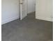 The bedroom showcases a grey floor and newly painted white walls at 4445 E Florida Ave, Denver, CO 80222