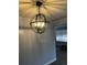 Modern dining room featuring a striking globe chandelier with metal frame and bright lighting at 4445 E Florida Ave, Denver, CO 80222