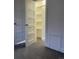 An open closet with built-in shelves, a bright interior, and fresh paint at 4445 E Florida Ave, Denver, CO 80222