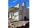 Home exterior featuring rock chimney, metal awning, stucco walls, and unique stonework at 4445 E Florida Ave, Denver, CO 80222