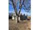 Angle view of the house behind a tree at 4445 E Florida Ave, Denver, CO 80222