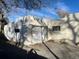White concrete backyard wall featuring a unique design and framed windows at 4445 E Florida Ave, Denver, CO 80222