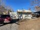 Quaint stucco home with an adobe style roof, small porch and detached garage at 4445 E Florida Ave, Denver, CO 80222