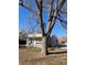 Front of the house behind a tree at 4445 E Florida Ave, Denver, CO 80222