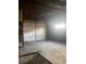 Unfinished garage interior featuring new white door and a concrete floor ready for customization at 4445 E Florida Ave, Denver, CO 80222