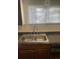 A close up of a stainless steel double basin sink with wood cabinets at 4445 E Florida Ave, Denver, CO 80222