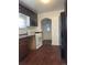 Kitchen featuring dark wood cabinets, linoleum floors, and white appliances at 4445 E Florida Ave, Denver, CO 80222