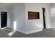 Bright living room with a niche detail, light walls, and carpeted floors at 4445 E Florida Ave, Denver, CO 80222