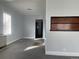 Open living area with gray walls, carpet, and a unique display nook at 4445 E Florida Ave, Denver, CO 80222