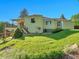 Backyard with a well-manicured lawn, deck, and partial view of the house's exterior at 6844 S Detroit Cir, Centennial, CO 80122
