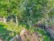 Landscaped backyard featuring mature trees, lush greenery, and tiered garden beds at 6844 S Detroit Cir, Centennial, CO 80122