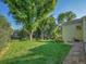 Lush green backyard with a small lawn, minimal landscaping, and the home's exterior at 6844 S Detroit Cir, Centennial, CO 80122