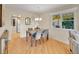 Inviting dining area featuring modern table set, hardwood floors, and a view of the yard at 6844 S Detroit Cir, Centennial, CO 80122
