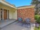 Cozy front porch with seating area featuring stylish outdoor furniture and a decorative rug at 6844 S Detroit Cir, Centennial, CO 80122