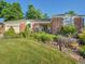 Landscaped front yard featuring a brick home with flowering plants and a well-maintained lawn at 6844 S Detroit Cir, Centennial, CO 80122