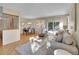 Bright and airy living room with hardwood floors, comfortable seating, and sliding doors to the backyard at 6844 S Detroit Cir, Centennial, CO 80122