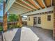 Covered patio with brick columns, concrete floor, and sliding glass doors to the house at 6844 S Detroit Cir, Centennial, CO 80122